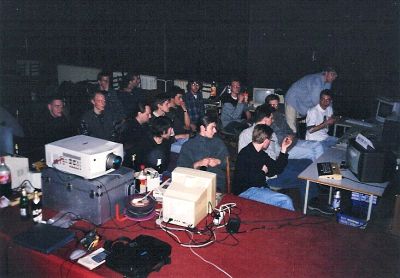 Atari sceners and audience looking at some big-screen show